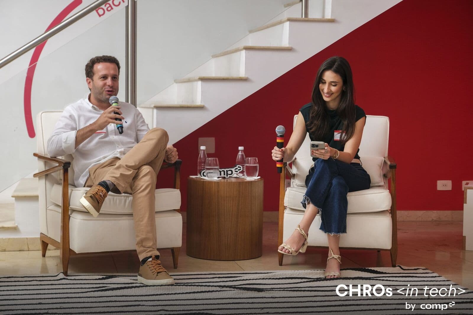 Fireside chat between two guests in armchairs