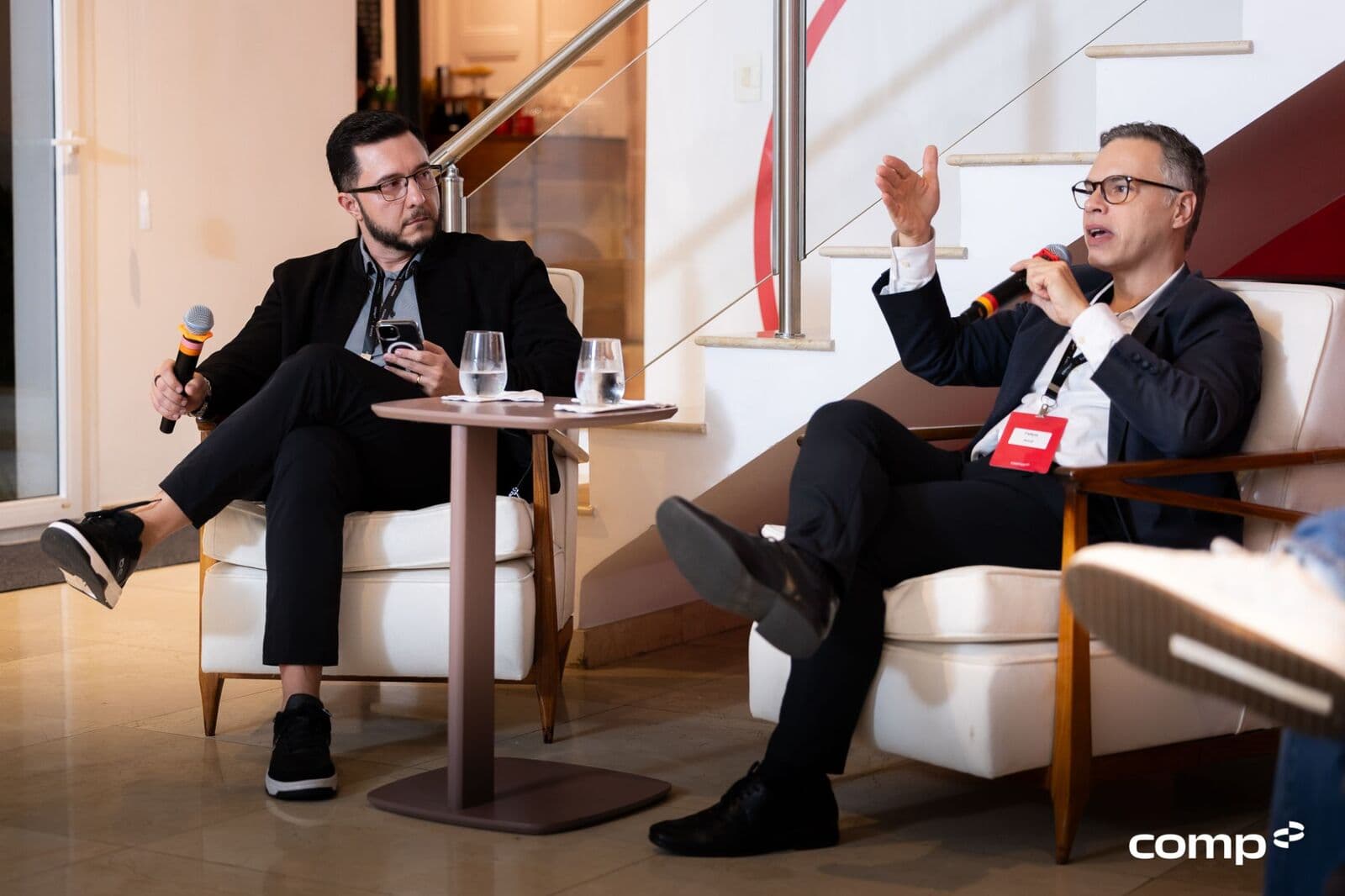 Two leaders debating in armchairs during the gathering